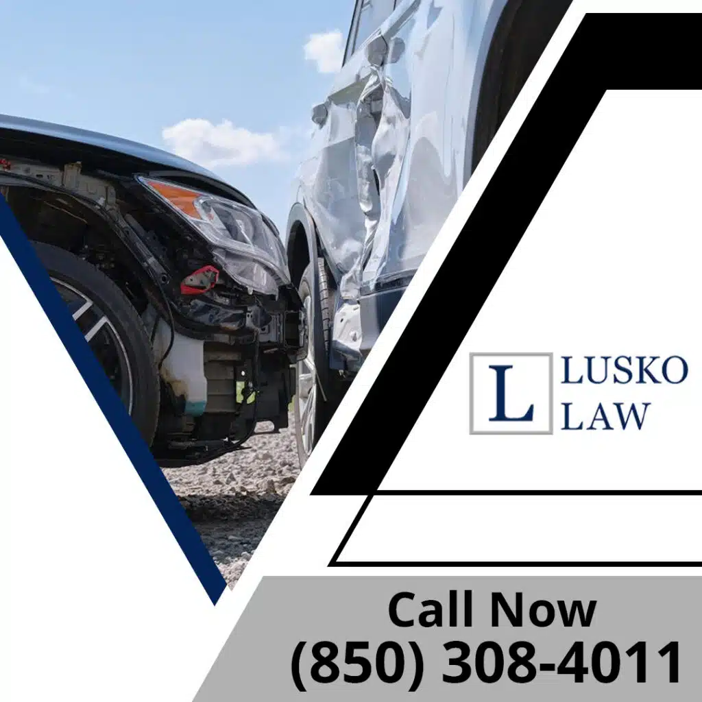 Two vehicles damaged in a T-bone side-impact collision next to the Lusko Law logo and contact phone number.